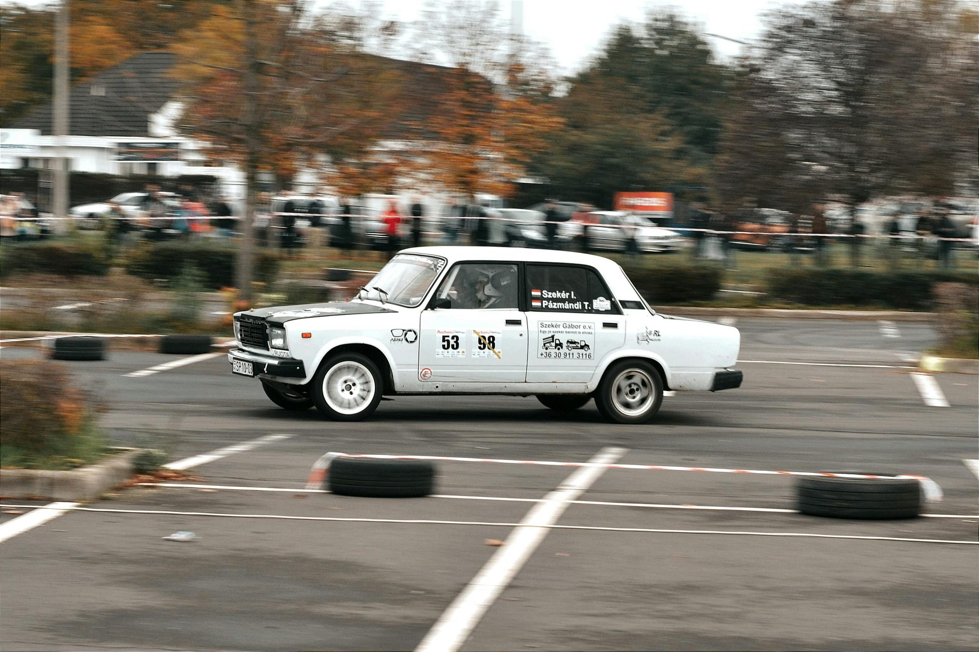 Classic car racing event in Hungary showcasing vintage sports cars in action.