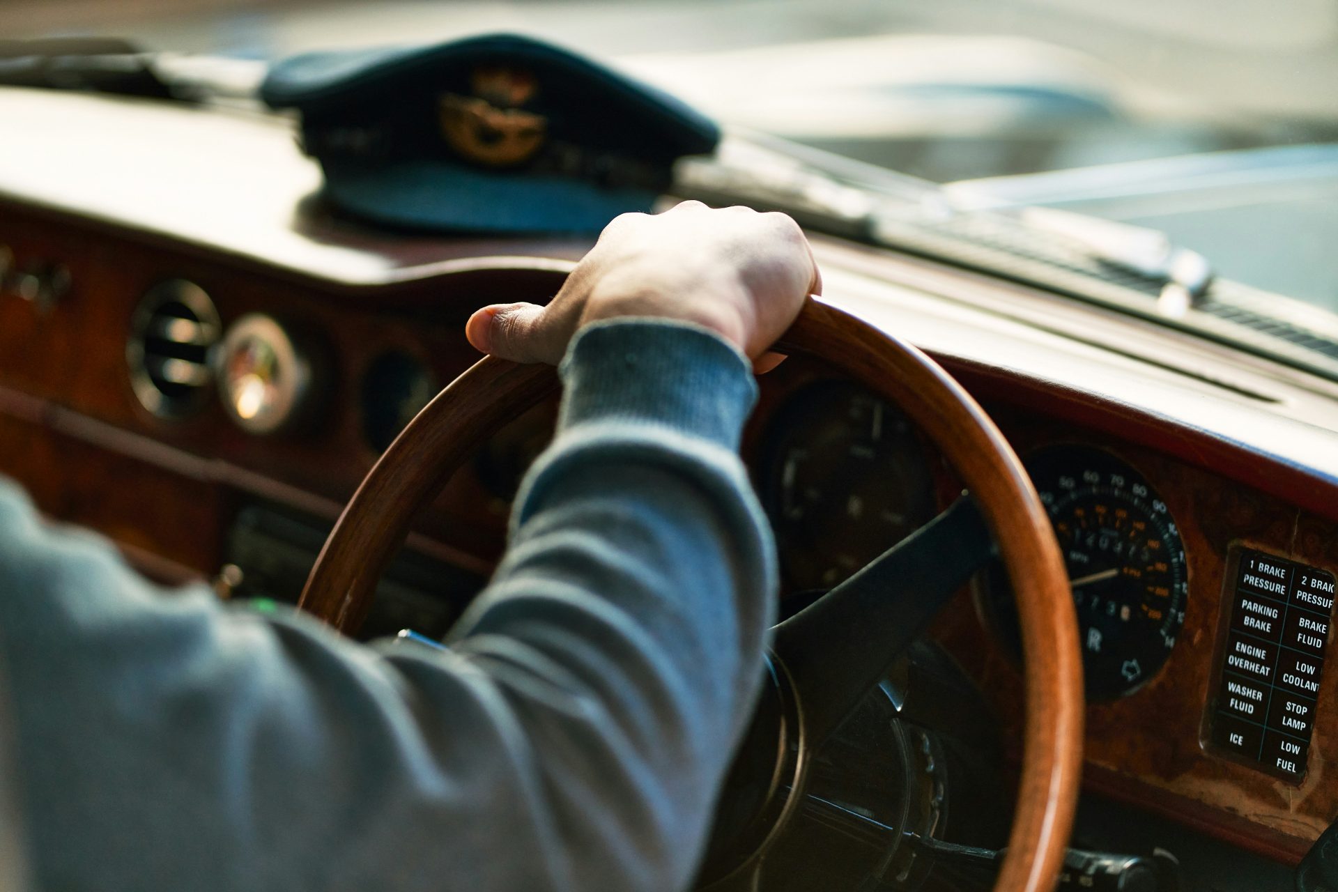 a person driving a car with a steering wheel