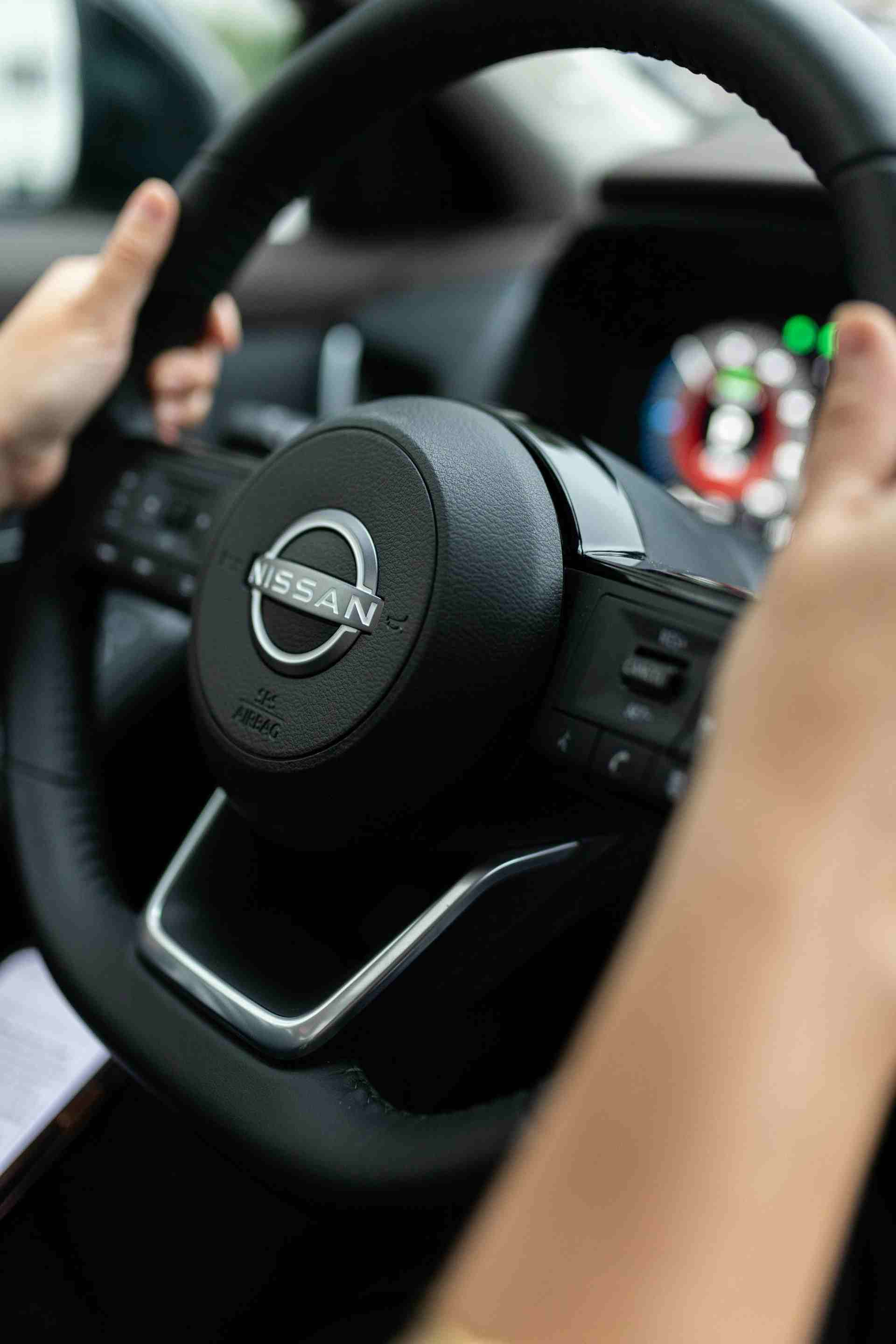 a person driving a car with a steering wheel
